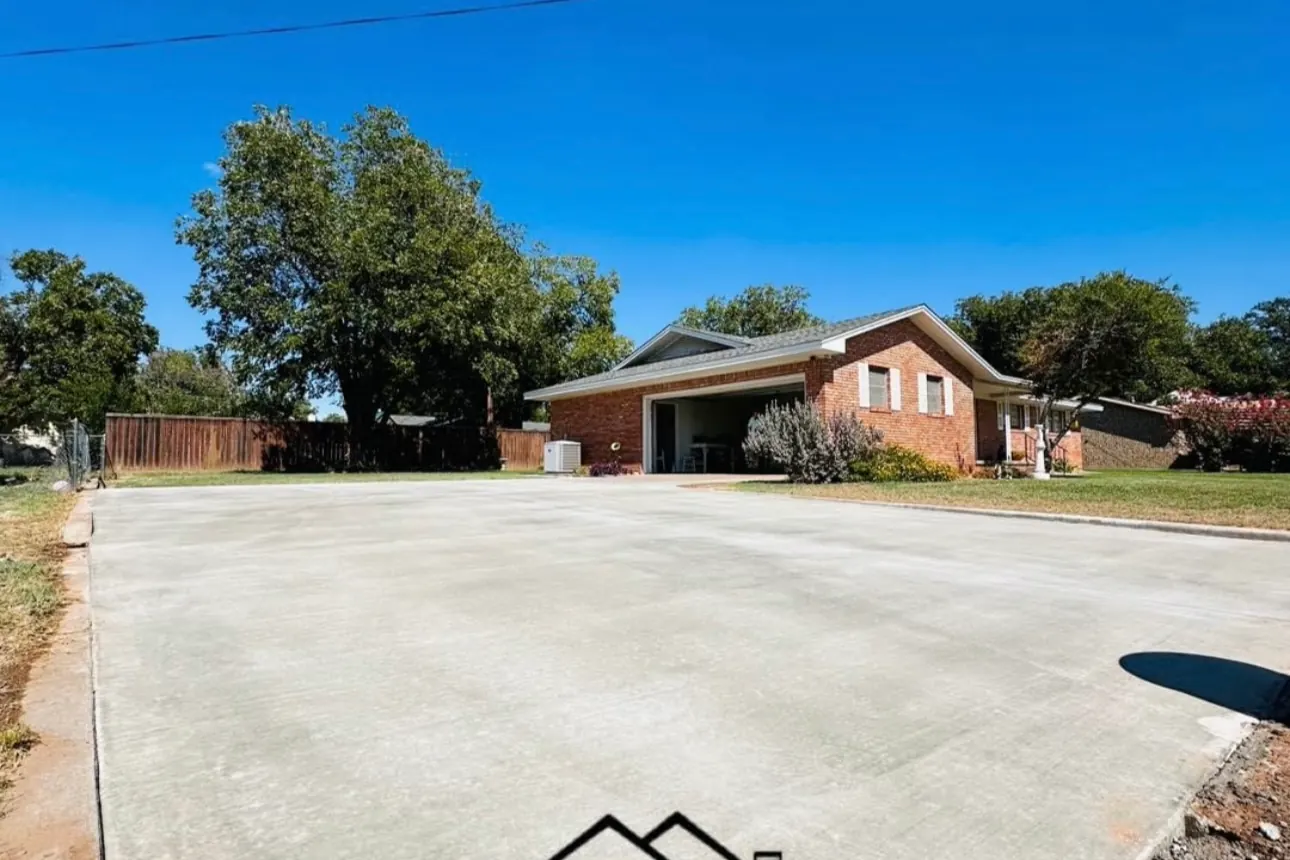 Wide residential concrete driveway by Double G Concrete Construction