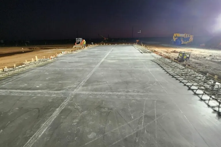 Concrete crew working a pour under lights at night