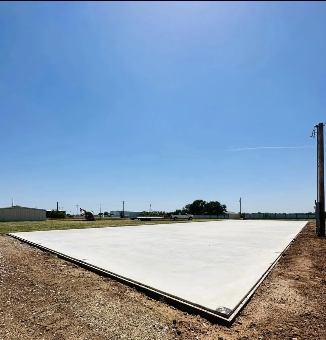 Wide concrete slab under the West Texas sun by Double G Concrete Construction