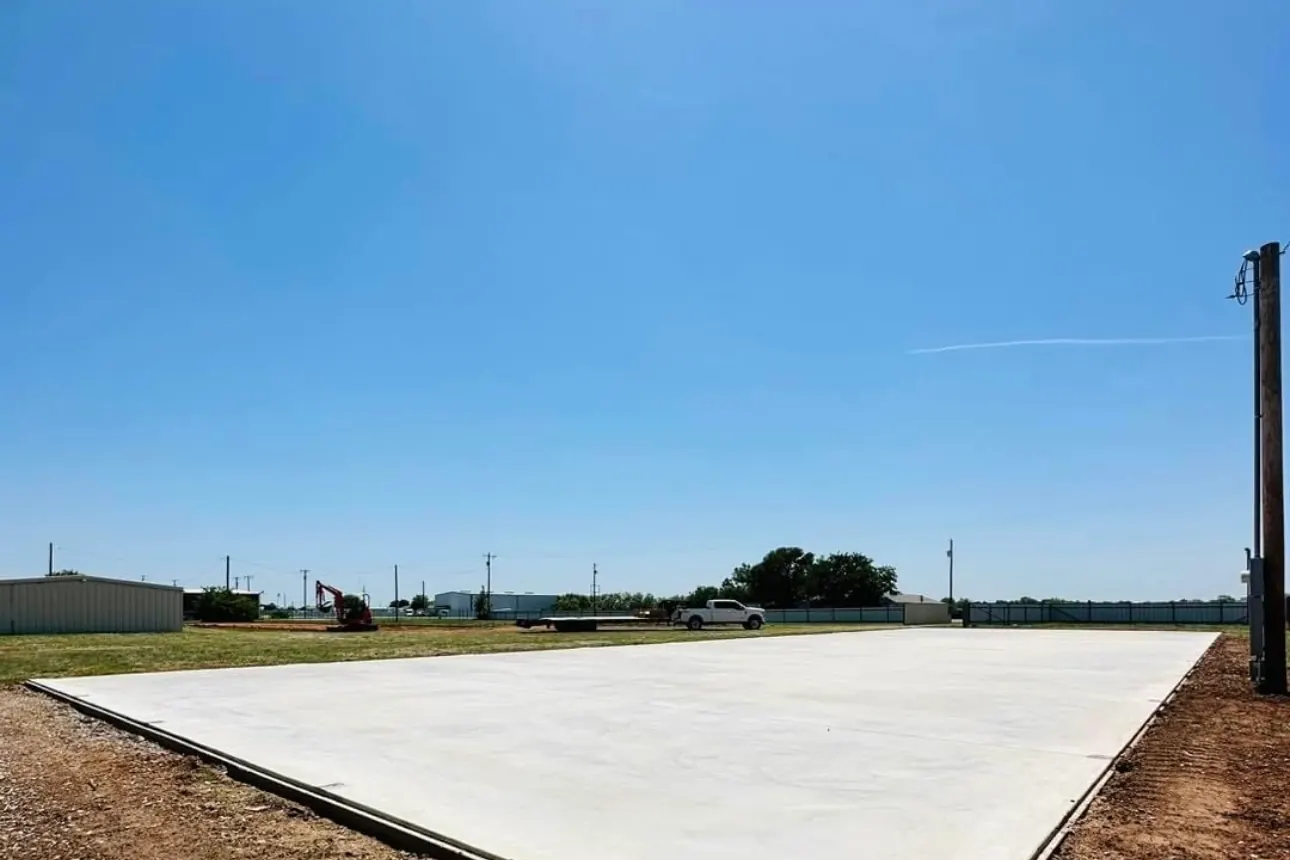 Finished concrete pad under a clear blue sky by Double G Concrete Construction