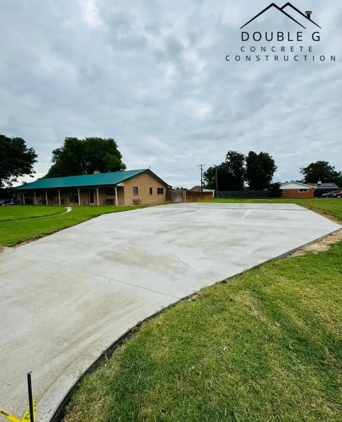 Large finished concrete slab beside a metal building by Double G Concrete Construction